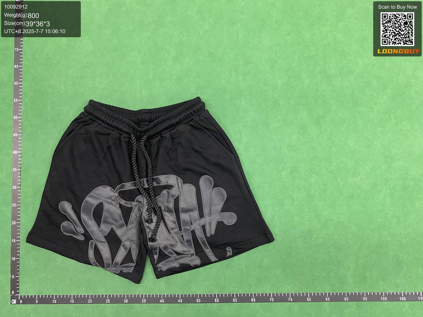QC photo of mesh shorts on the inspection mat with ruler, weight and size